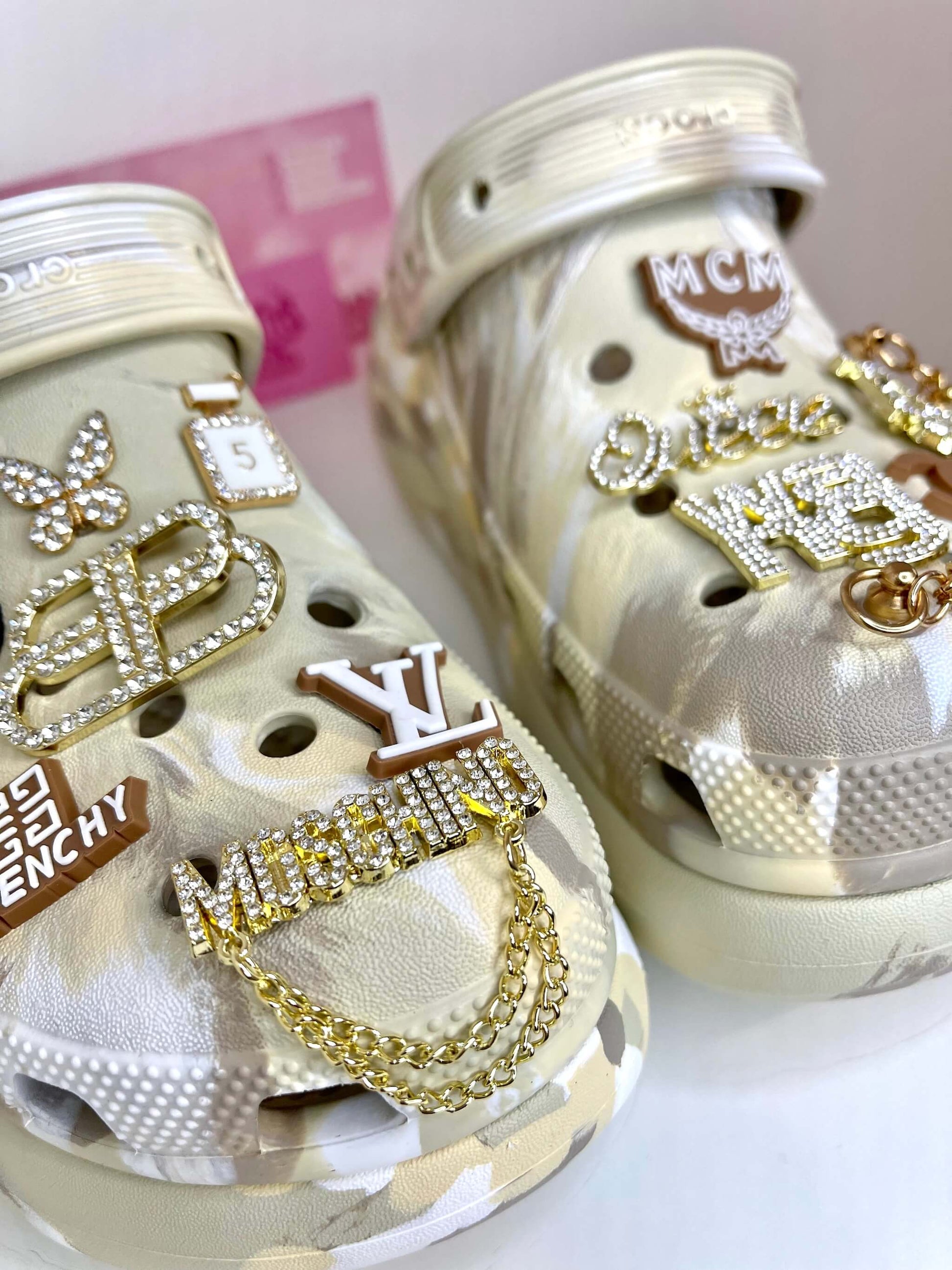 Paire de Crocs beige à plateforme personnalisée avec les charms du set "Luxury Brown", vue de près